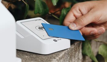 Paying with a blue credit card by tapping