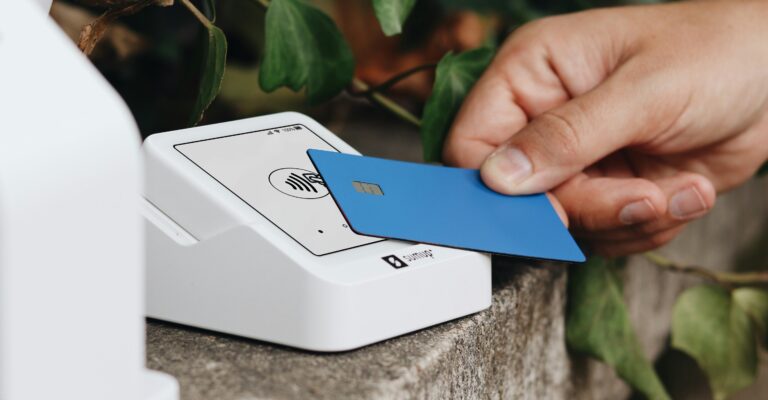 Paying with a blue credit card by tapping