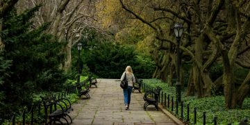 Woman walking a pathway in Central Park